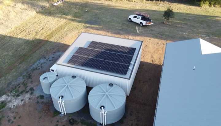 Off-grid shed with rainwater tanks, installed by High Energy